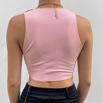 a woman wearing a pink crop top and black pants